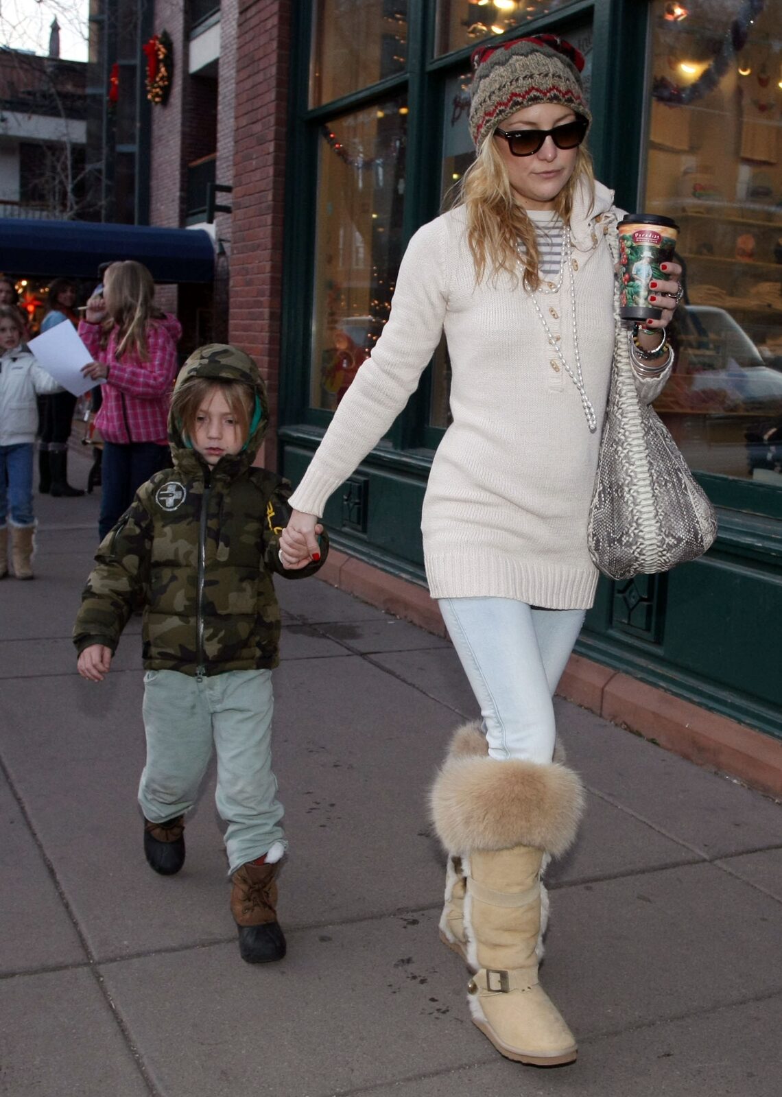 Kate Hudson holds tight to bundled up son Ryder in Colorado, where the actress is spending the holidays with her famous family.