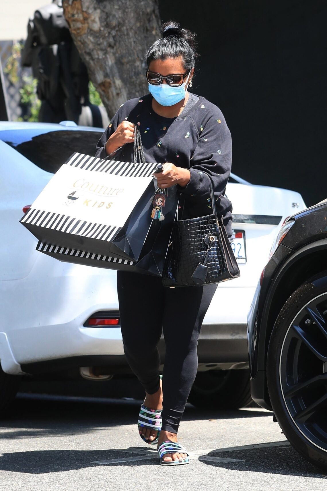 Mindy Kaling returned to her car with large shopping bags after a trip to Couture Kids on Robertson in West Hollywood.