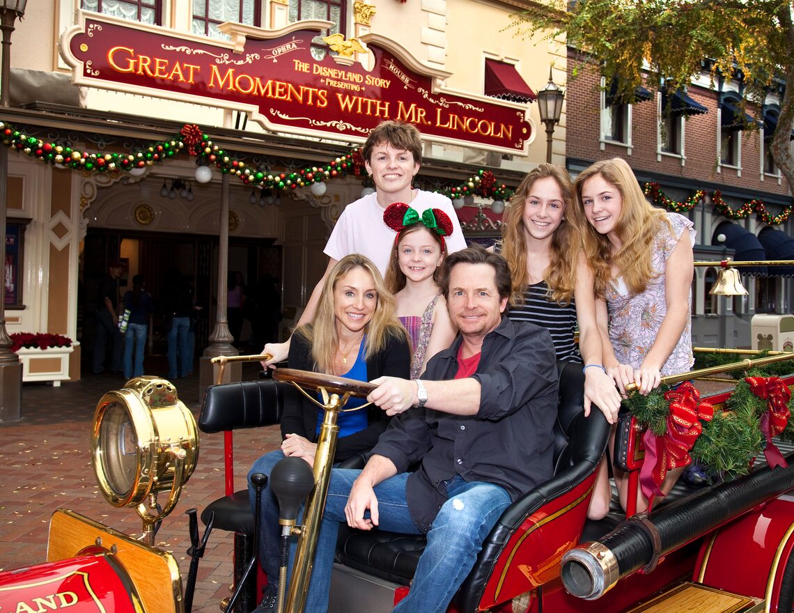 Michael J. Fox, wife Tracy Pollan and their four children hop aboard Walt Disney's antique fire truck at Disneyland.