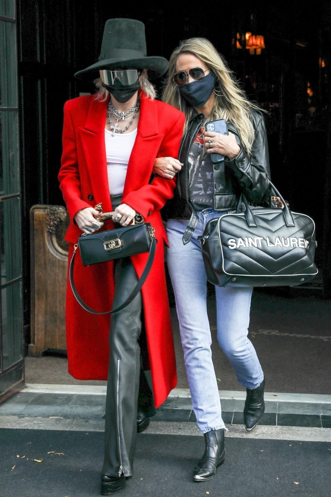 Miley Cyrus hid her face under a mask and huge sunglasses while stepping out of her hotel with mom Trish in NYC.