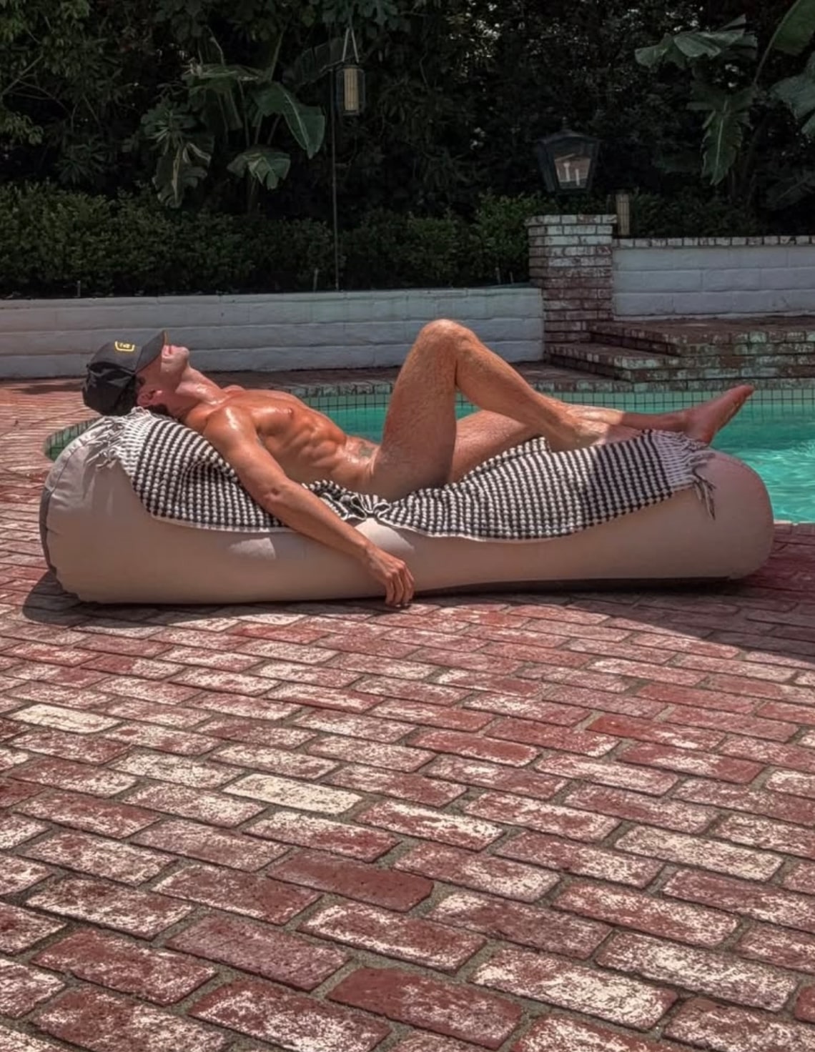 "Dancing with the Stars" pro Sasha Farber, who recently split from "Bachelorette" alum Jenn Tran, did some naked sunbathing by his pool. He posted, "Why is it soooooo hot today???"