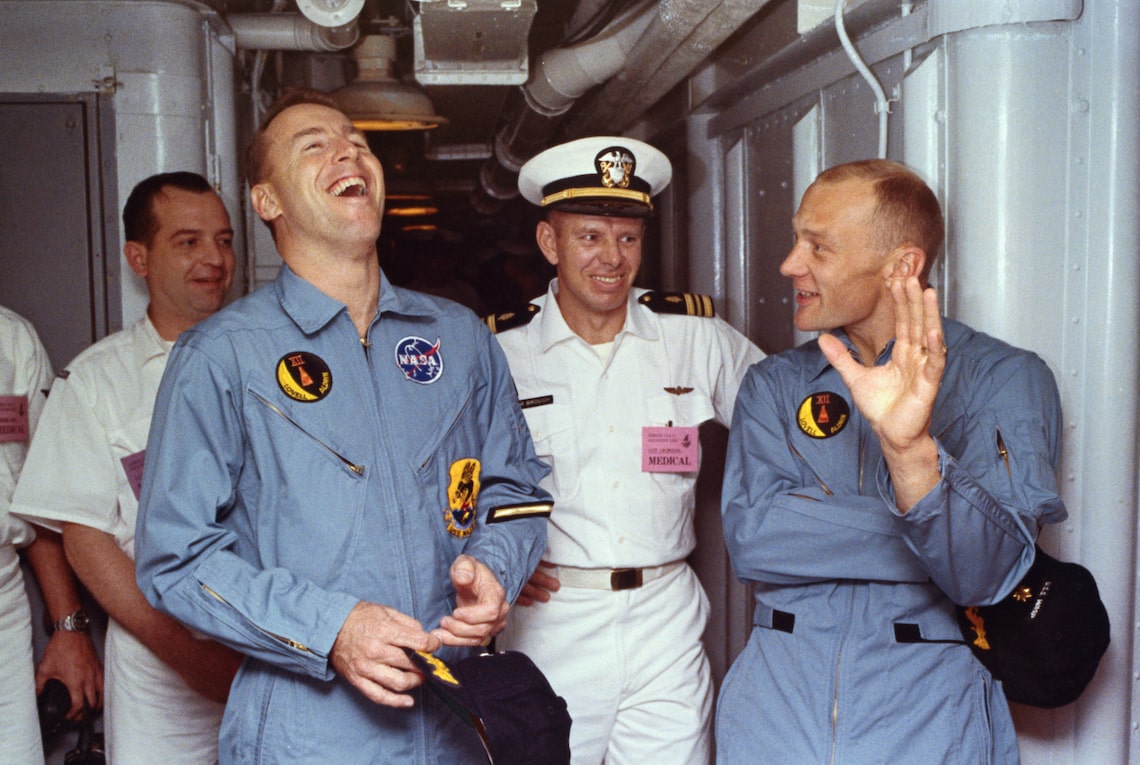Jim Lovell (laughing at L), the astronaut who led a three-man crew through the Apollo 13 space disaster in 1970, died August 7 at 97. He was immortalized by Tom Hanks in the Ron Howard drama "Apollo 13."
