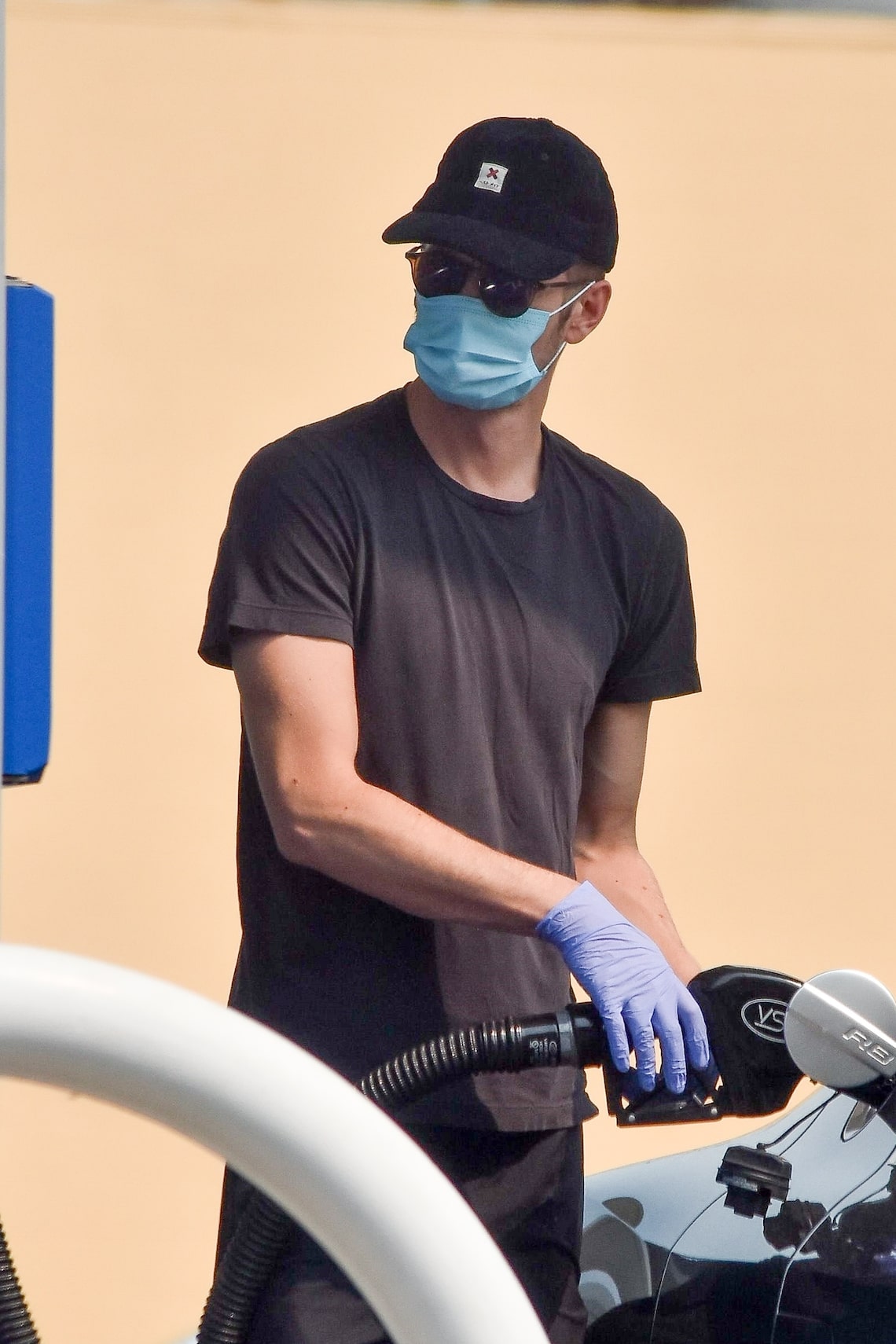 Actor Hayden Christensen wore gloves and a mask while filling up his tank at a gas station in Studio City, California.